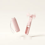 Ventilateur de poche pliable Hélios, coloris Rose, vue plié et déplié, fond crème